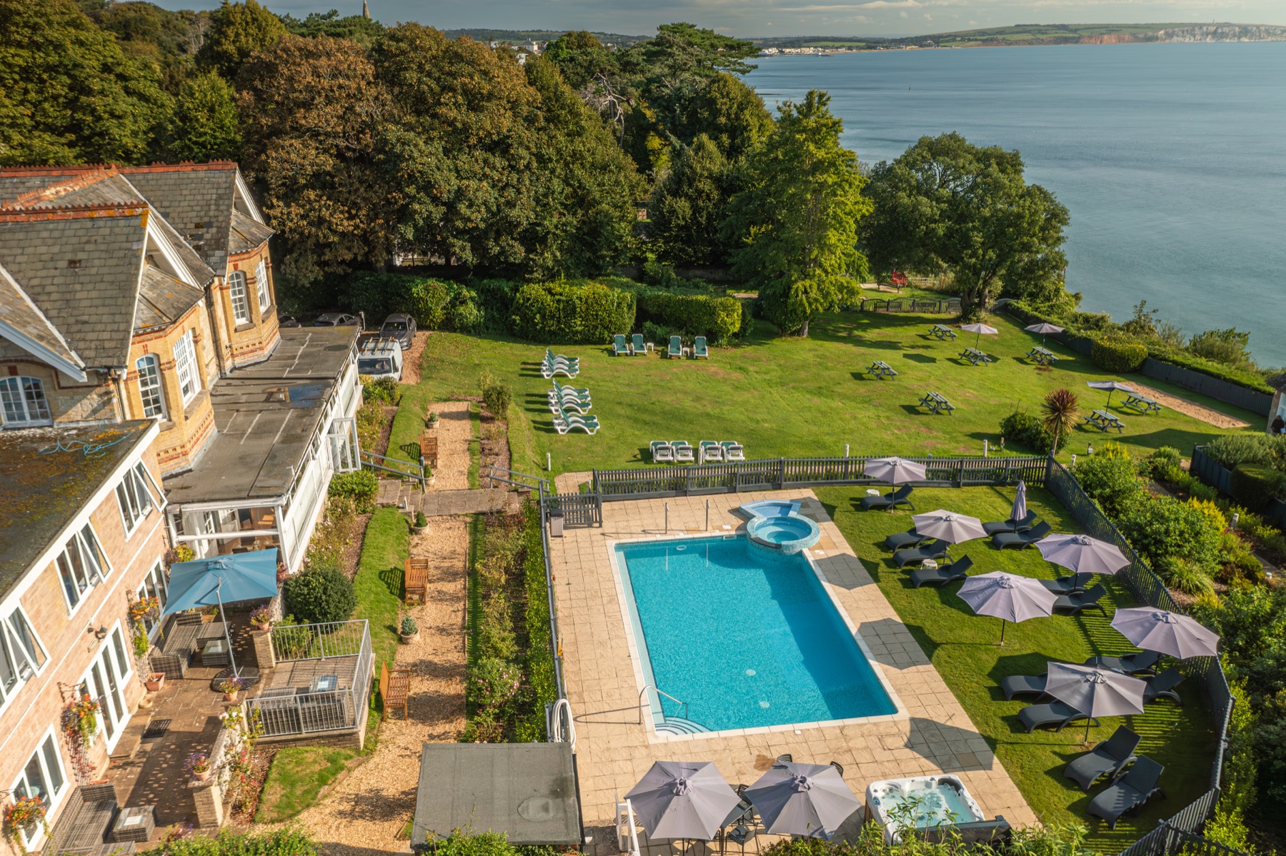 The outdoor pool and lawns looking out over Sandown Bay